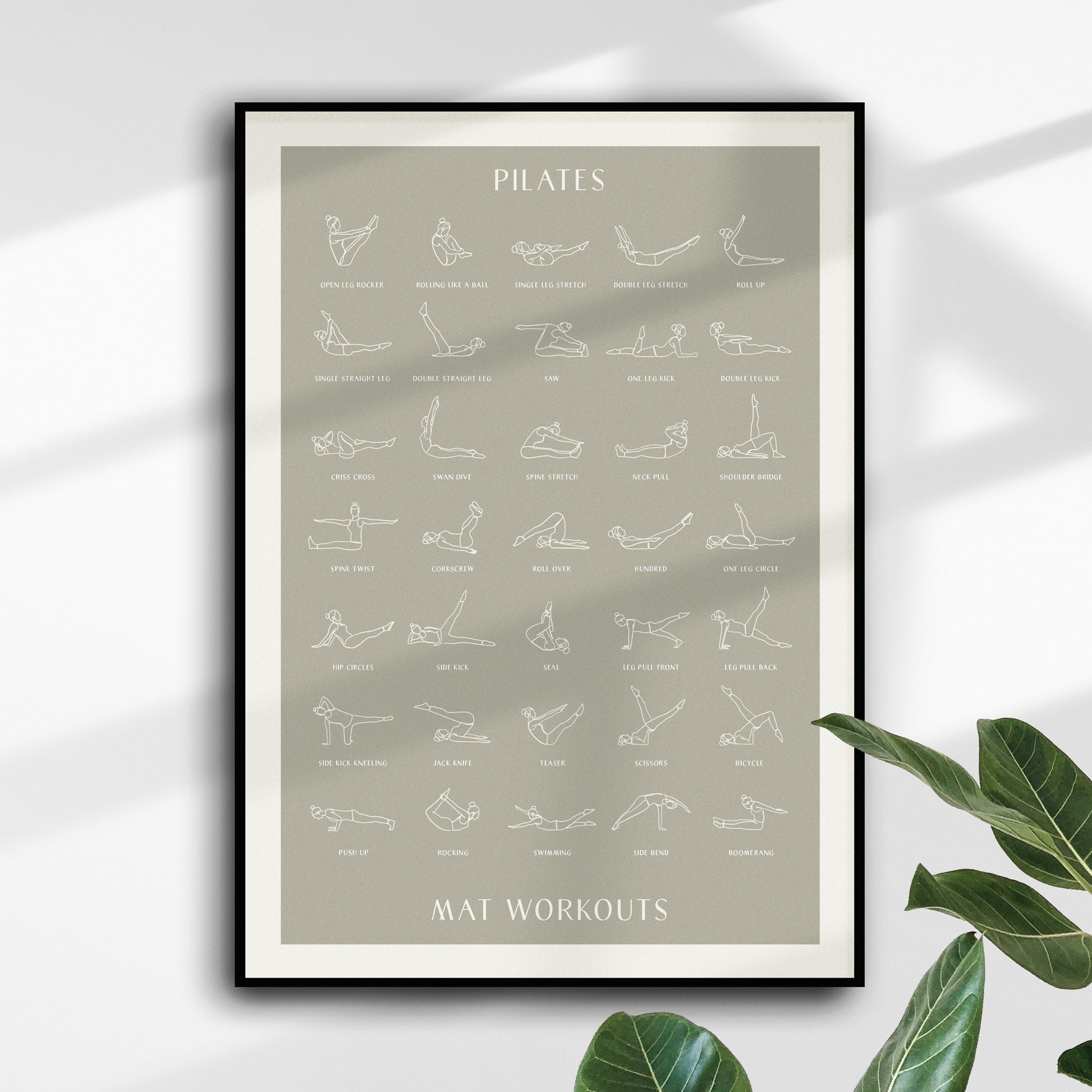 Pilates Mat Workout poster print sage olive green hanging on wall with shadows casting across the wall