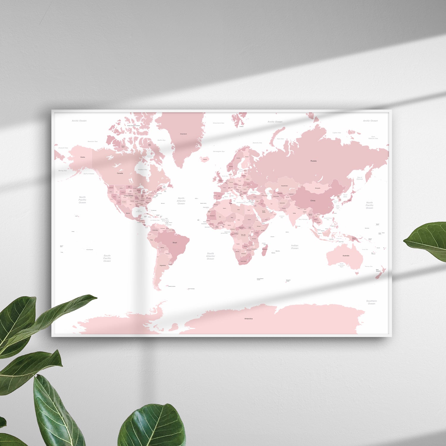 Pink map of the world print poster on wall with shadows