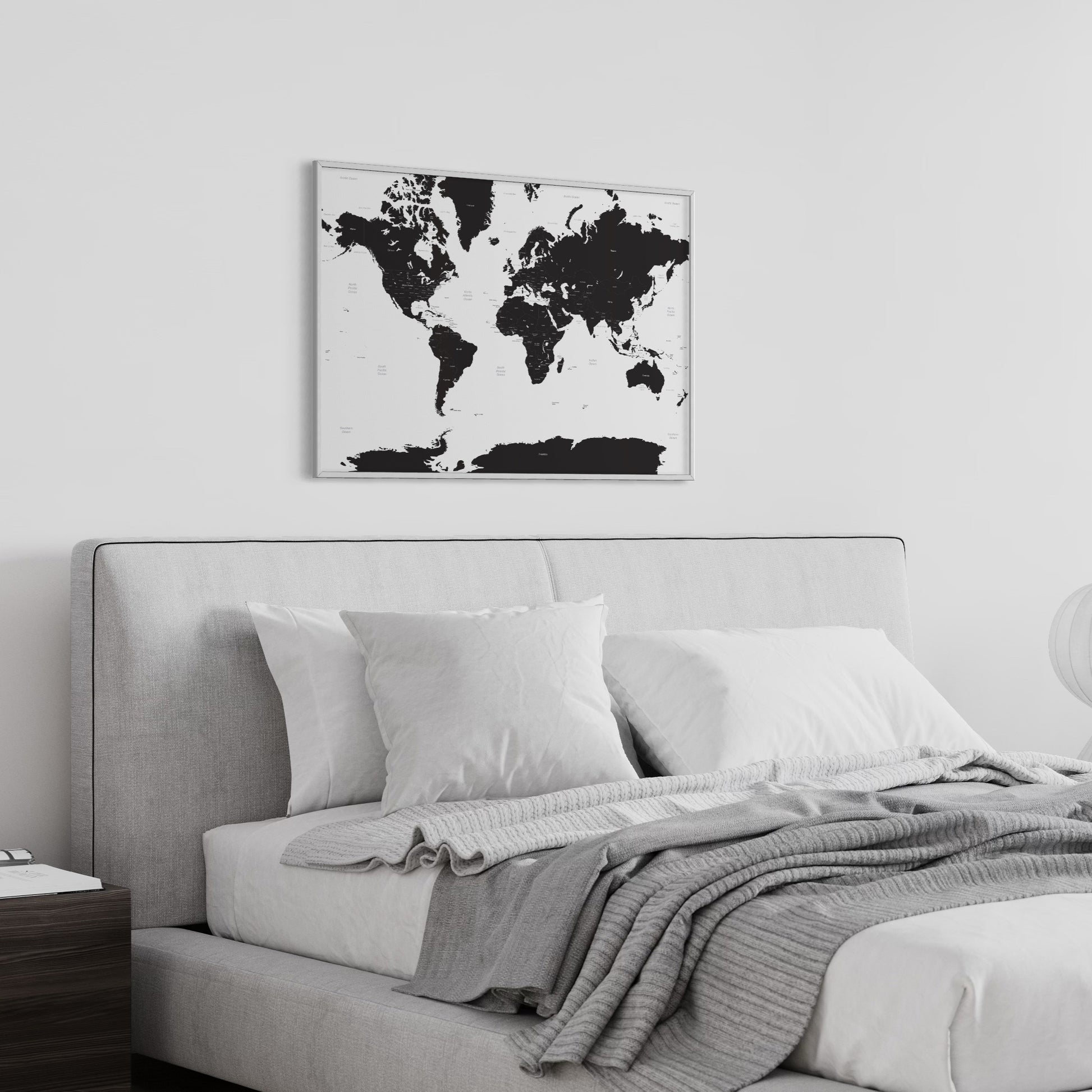 White Sea Black Countries Map of the World on Wall Above Grey Bed